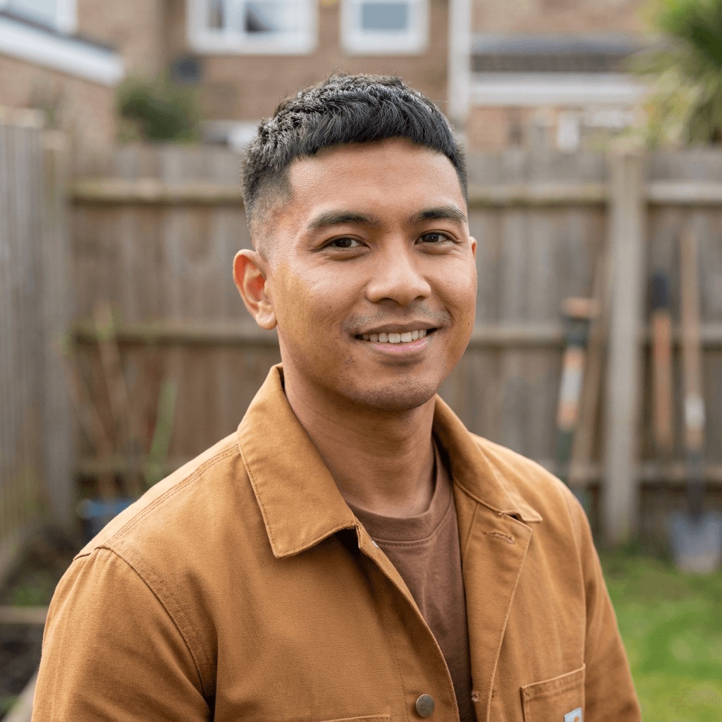 David Okonkwo in a casual button-up shirt at home